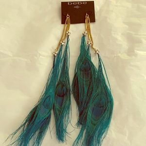 BEBE RARE, NWT Feather duster earrings, 12” long.